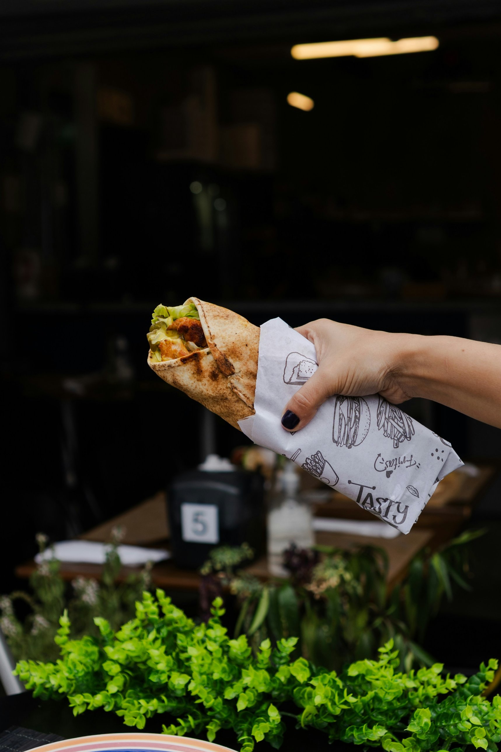 Gerollte Pita in der Hand